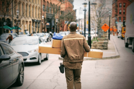 Delivery man holding packages for returns