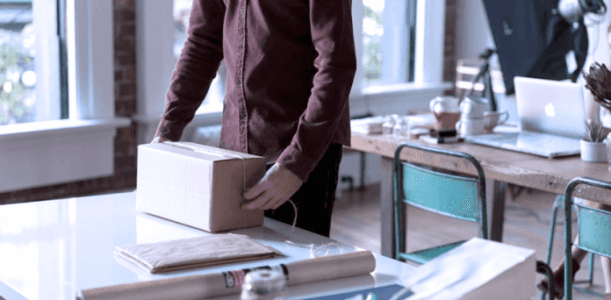 Man opening a package in office